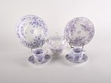 purple and white porcelain dishes and cups and saucers