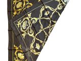 a close up of a black and gold scarf on a white background