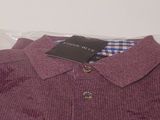 the shirt is purple and has a checkered collar on it