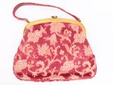 a pink purse with a gold handle on a white background