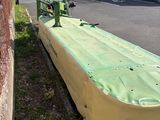 a yellow boat that is sitting on the side of the road