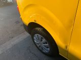 a yellow van that is parked on the side of the street