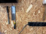 a black cord plugged into the wall next to a black power strip