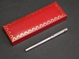 an image of a pen and a red box on a table