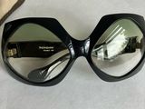 sunglasses on a table with a case and a pair of glasses