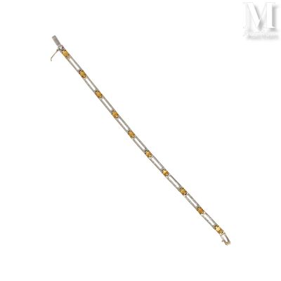 a close up of a yellow and silver bracelet on a white background