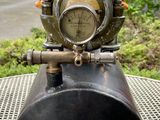 a statue of a teddy bear sitting on top of a gas tank
