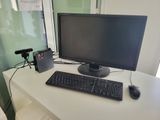 an image of a computer desk with a monitor and keyboard