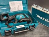a box with a drill and a tool in it