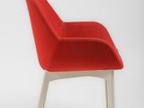 the chair is red and white with a wooden legs