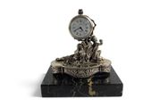 a clock that is sitting on top of a marble block
