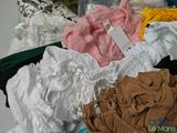 a pile of clothes that is sitting on top of a table