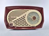 an old fashioned radio sitting on a white surface