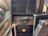 a machine that is sitting on the ground next to a trash can