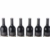 quatre bouteilles de vin sont alignées sur une table