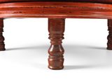 a wooden bench with a red seat on a white background