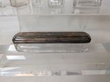 a glass box with a silver lid sitting on a table