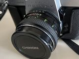 a camera sitting on a table next to a laptop