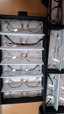 a lot of glasses that are sitting on a shelf