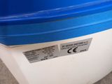a blue and white container sitting on the ground