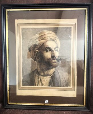 a framed picture of a man with a turban on his head