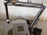 an image of a microscope with a monitor and a pen