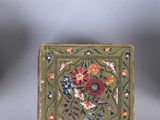 three small boxes with decorative designs on them sitting next to each other