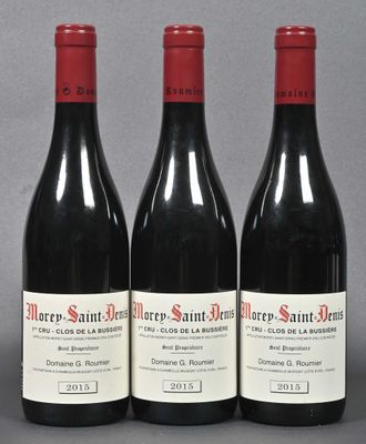 three bottles of red wine sitting on a table next to each other