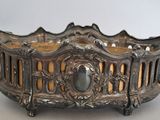 an antique silver plate with a mirror in the middle of it