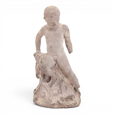 statue of a boy on a rock with a dog