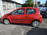 a small red car parked in front of a building