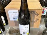 several bottles of wine sit on a table in front of a box of wine