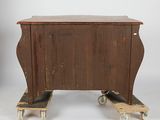 a small wooden table on wheels with a wooden top