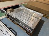 a large metal tray on a pallet in a warehouse