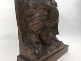 a close up of a statue of a bear on a wooden base