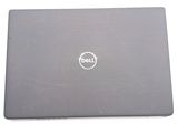 laptop with dell logo on the back of it sitting on a white surface