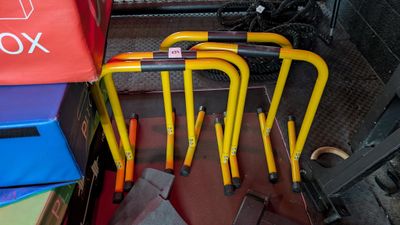 a lot of yellow and red bike racks on the floor