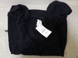 the shirt is black and has a white tag on it