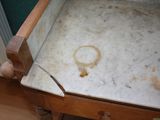 a dirty bed with a wooden frame on the floor