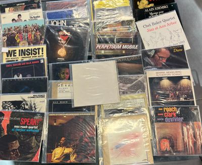 a lot of music cds and cds on the table