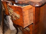 a small wooden table with a drawer on top of it