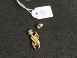 a close up of a gold necklace with a tag attached to it