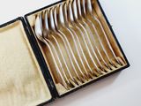 a box with silverware in it on a white surface
