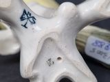 a close up of a figurine of a bird on a table