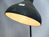 a black lamp with a white label on it
