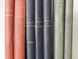books are lined up in a row on a white surface