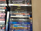 a lot of dvd ' s in a box on the floor