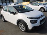 the white citrole is parked in a parking lot next to other cars