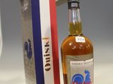 a bottle of alcohol sitting next to a box on a counter