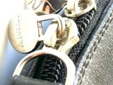 a close up of a purse with a key in it